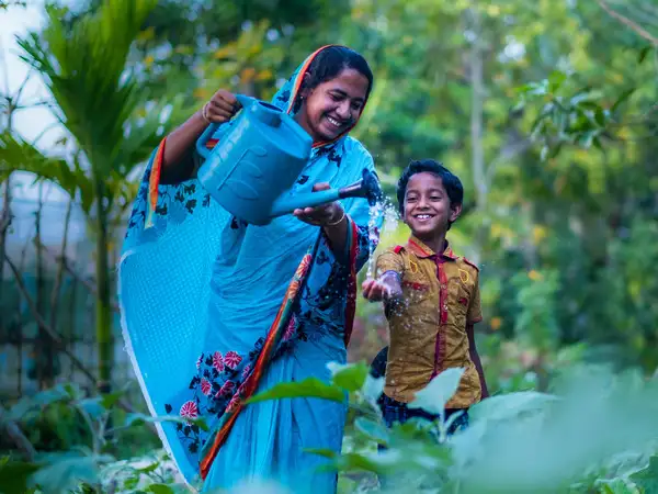 Mother and son in their garden in Bangladesh