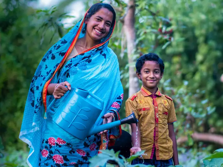 Shukla and her son in their garden in Bangladesh