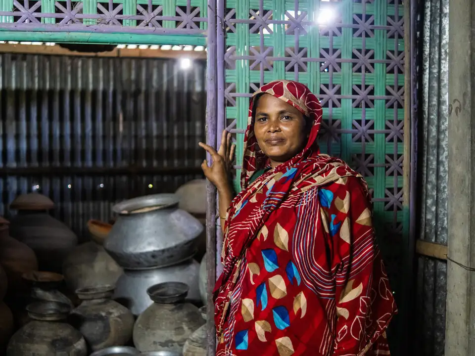 Salina standing next to her seed store room