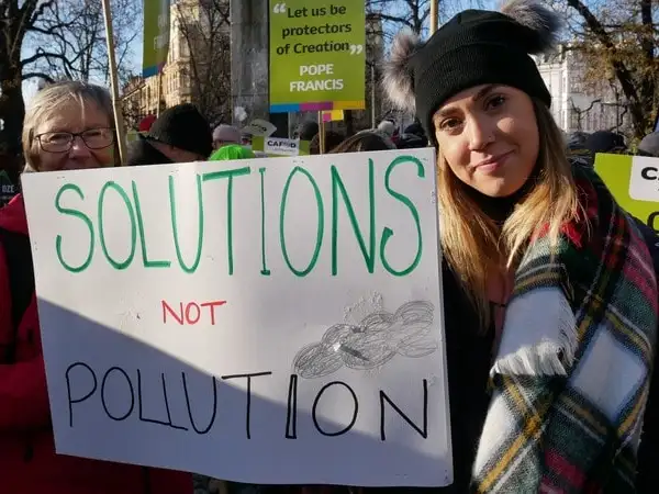 Europe - Poland - COP24 - CAFOD campaigner Hannah Jordan holding placard